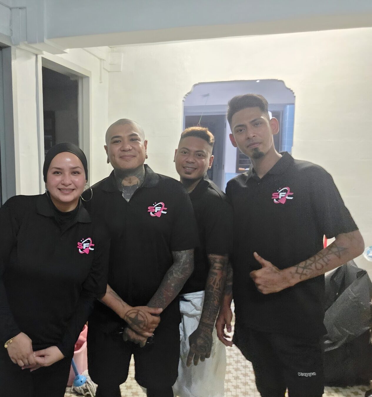 The four SFC Cleaning Services field crew in their branded polos on site